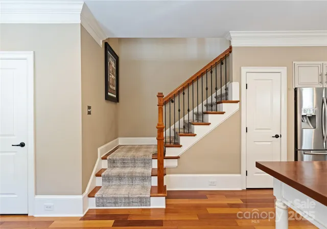 a view of entryway and hall with wooden floor