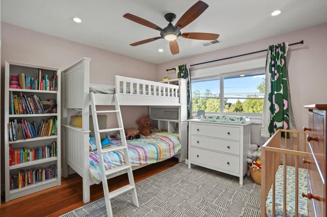 a bedroom with a bed window and a book shelf