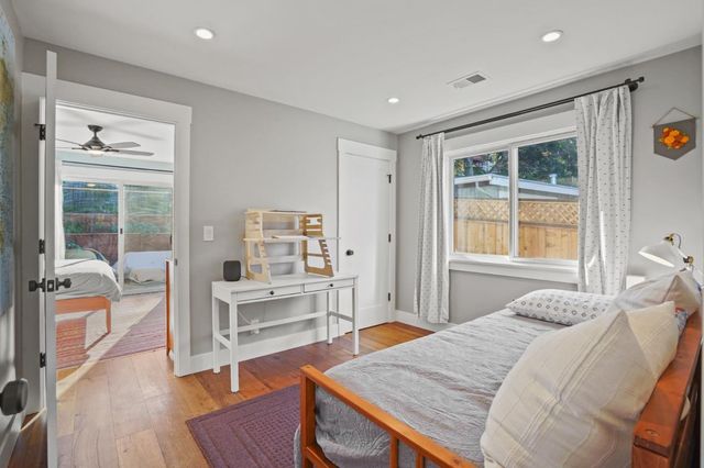 a bedroom with a bed and wooden floor