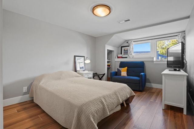 a bedroom with a bed and a bookshelf