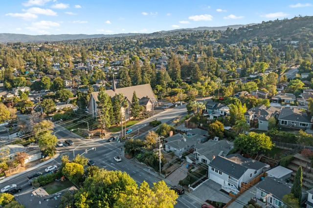 a view of a backyard with couches and a potted plant