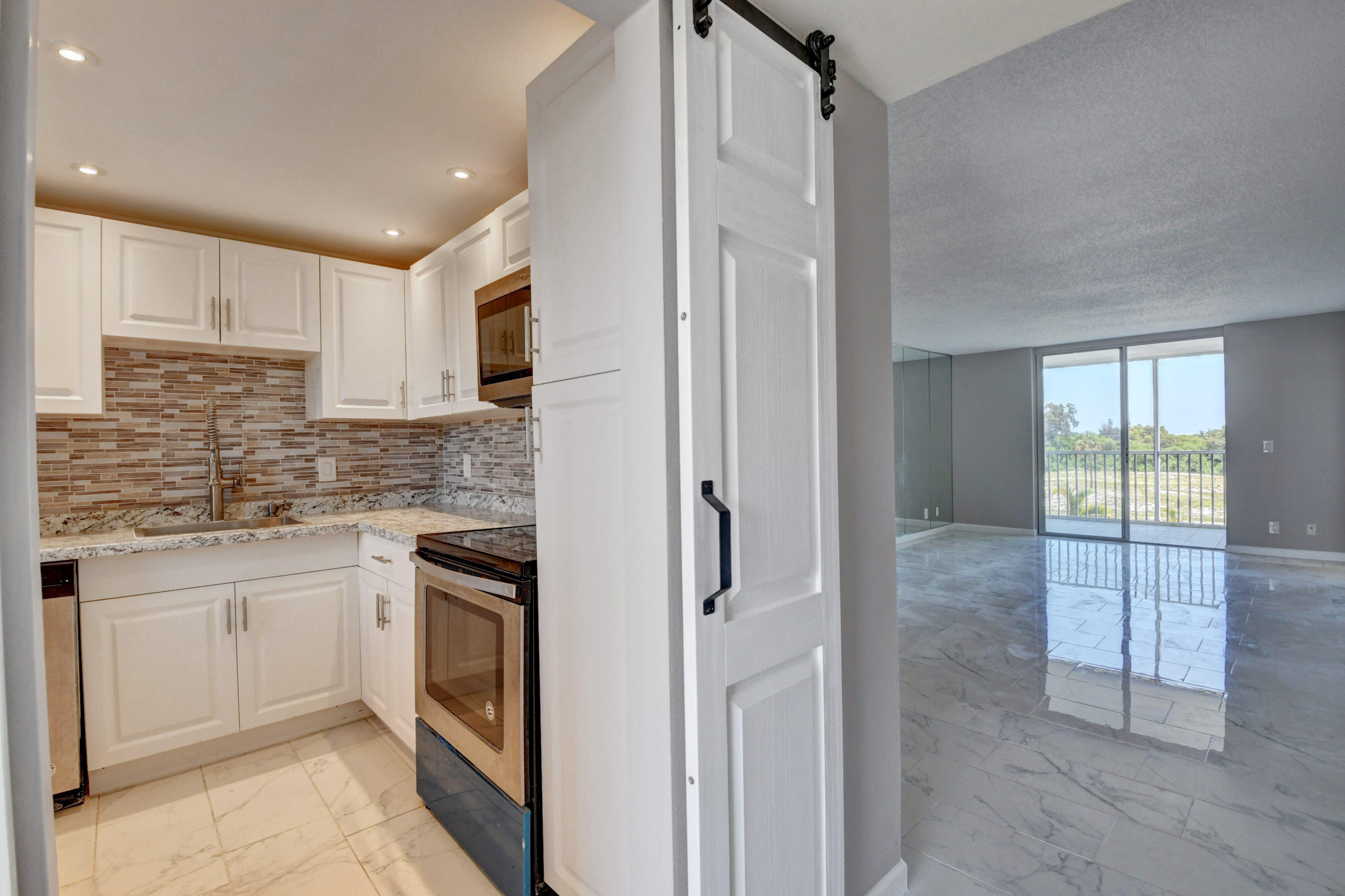 a kitchen with stainless steel appliances granite countertop a refrigerator and a sink