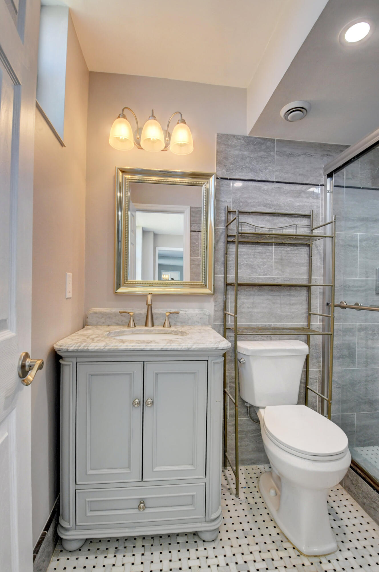 5500 Northwest 2nd Avenue, Unit 418 Boca Raton, FL 33487 - Photo 16 of 43 a bathroom with a toilet a sink and mirror
