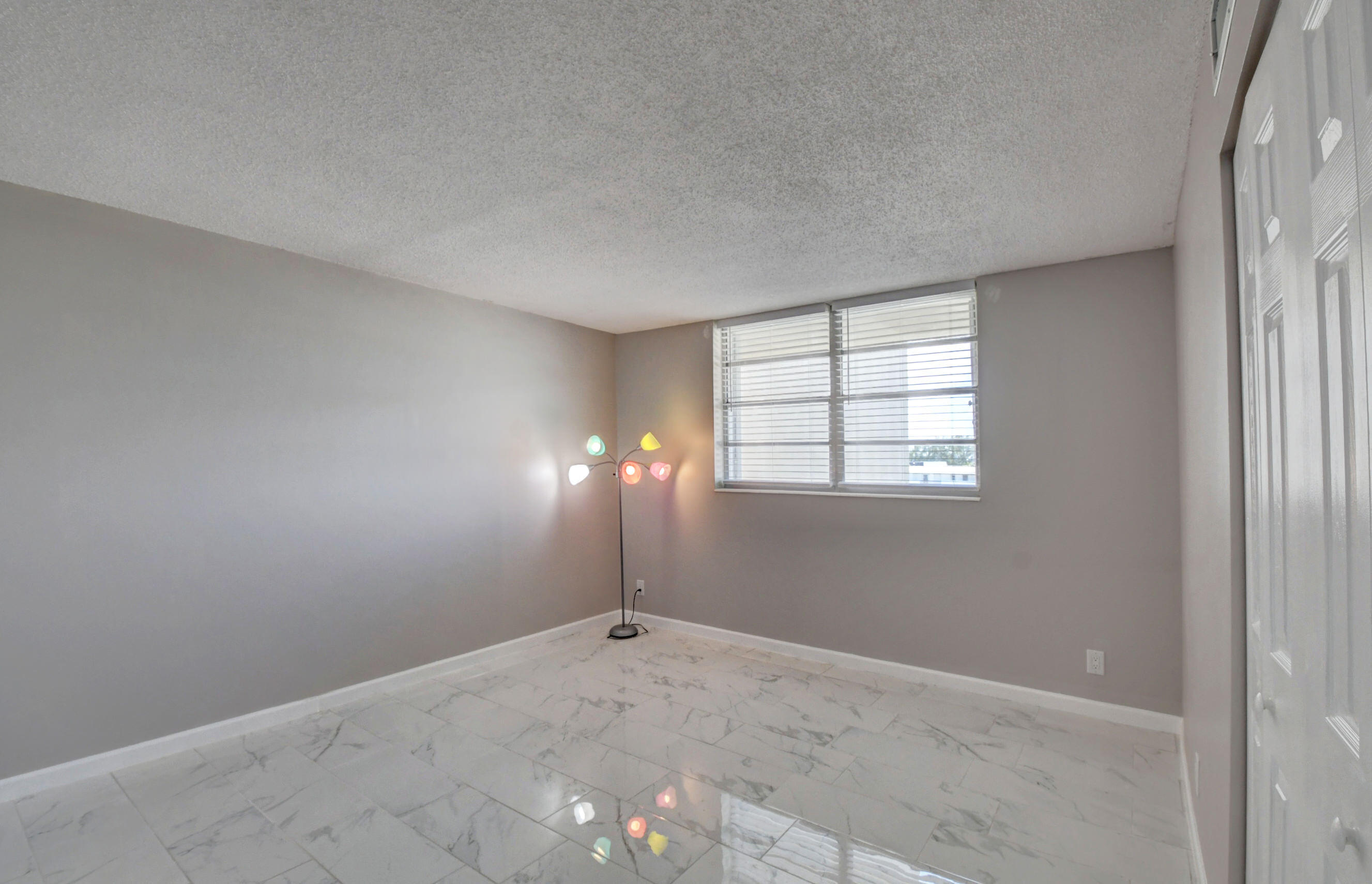5500 Northwest 2nd Avenue, Unit 418 Boca Raton, FL 33487 - Photo 22 of 43 an empty room with windows and closet