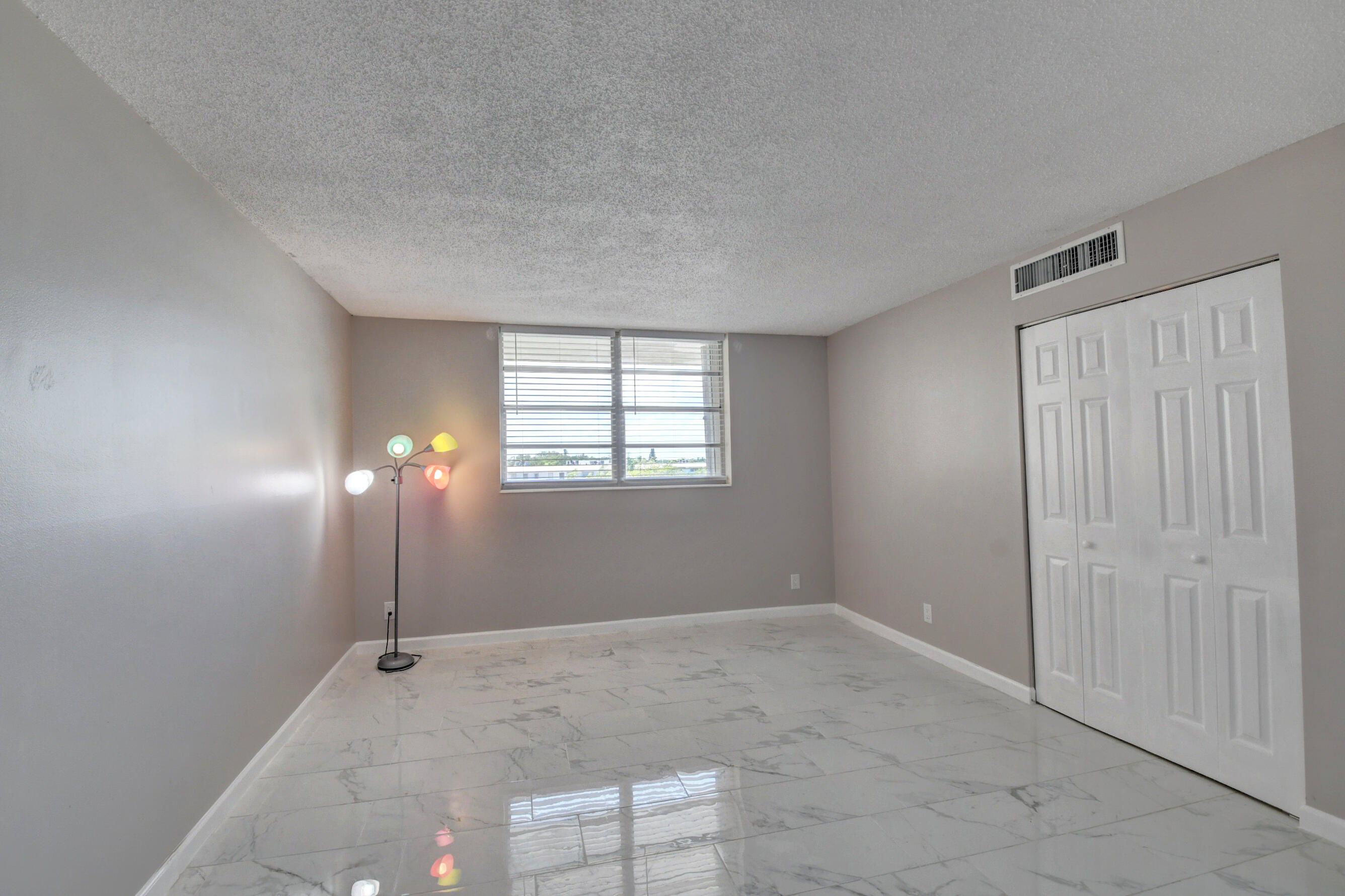 5500 Northwest 2nd Avenue, Unit 418 Boca Raton, FL 33487 - Photo 23 of 43 an empty room with windows and closet