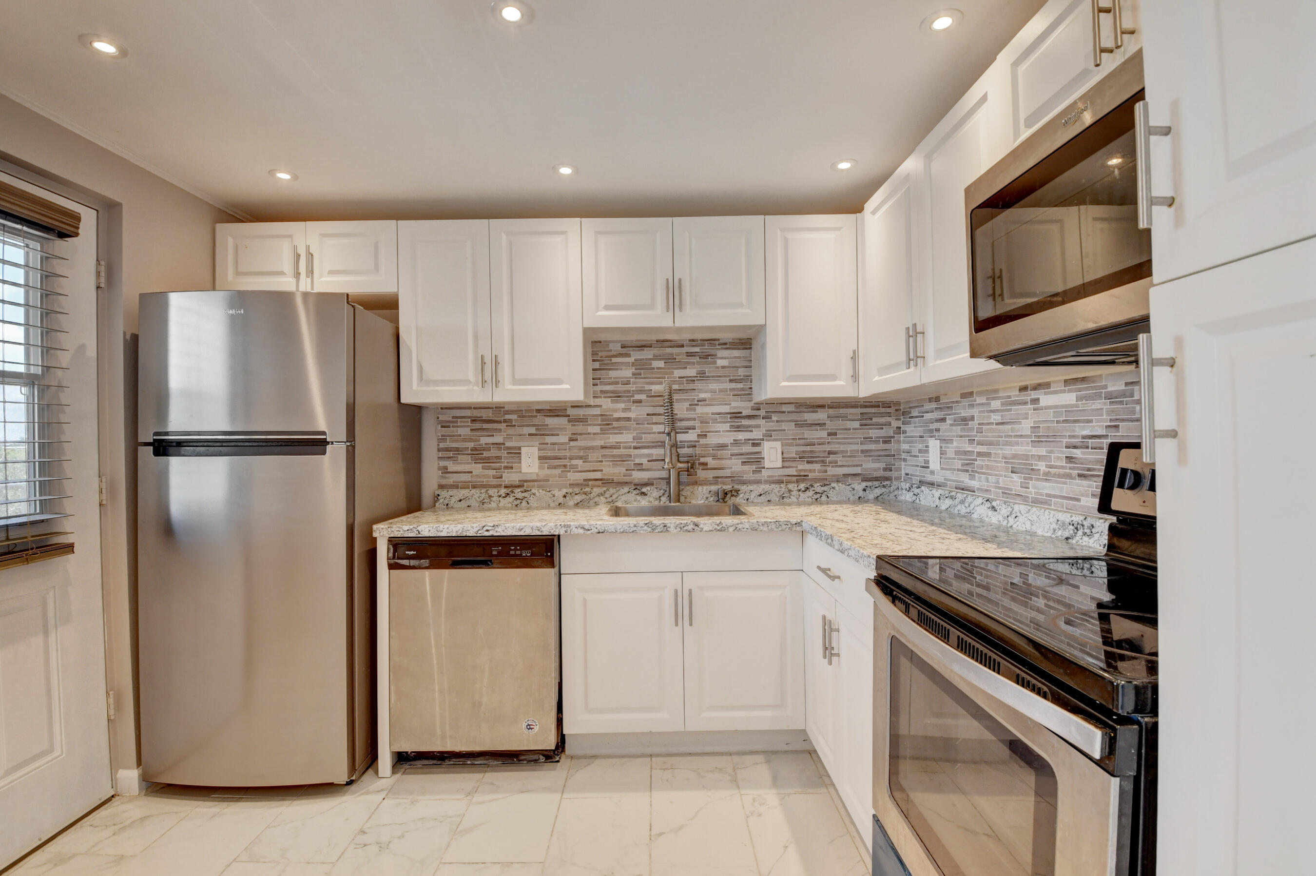 5500 Northwest 2nd Avenue, Unit 418 Boca Raton, FL 33487 - Photo 30 of 43 a kitchen with a refrigerator sink and microwave
