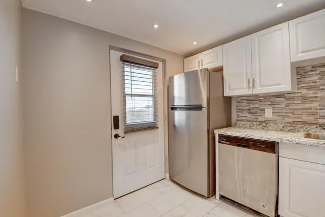 a view of a chairs and table in patio with a yard