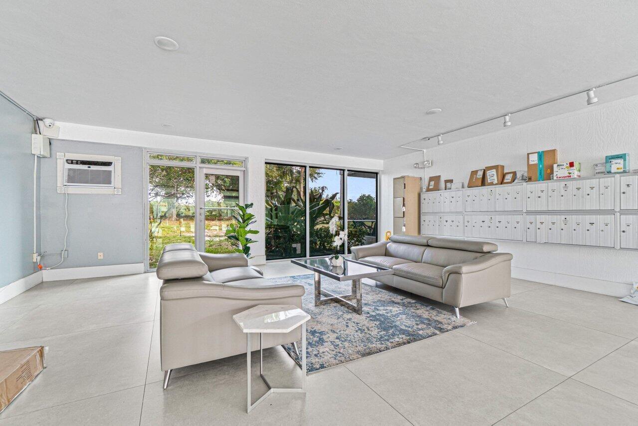 5500 Northwest 2nd Avenue, Unit 418 Boca Raton, FL 33487 - Photo 5 of 43 a living room with furniture and a large window