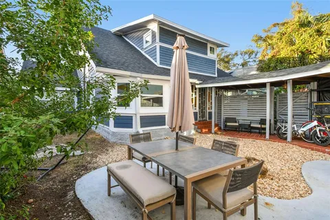 a view of a house with backyard sitting area and garden