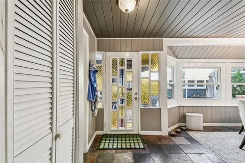 a view of a hallway with wooden floor and closet