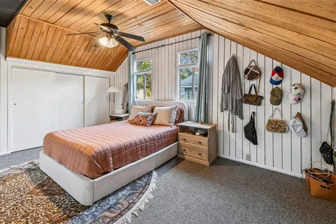 a bed sitting in a bedroom next to a window