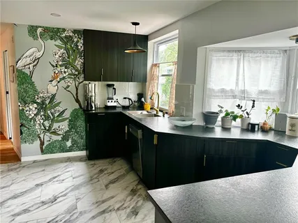 a kitchen with a refrigerator and a stove top oven