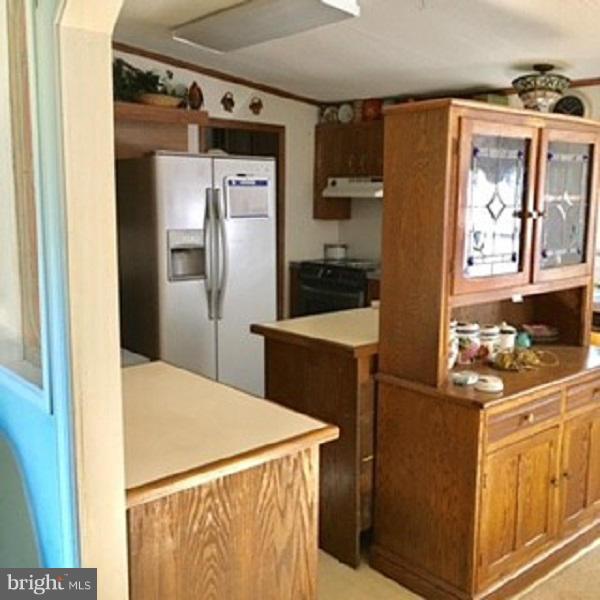 1044 Spielman Road Berkeley Springs, WV 25411 - Photo 12 of 25 a kitchen with stainless steel appliances a refrigerator and a stove