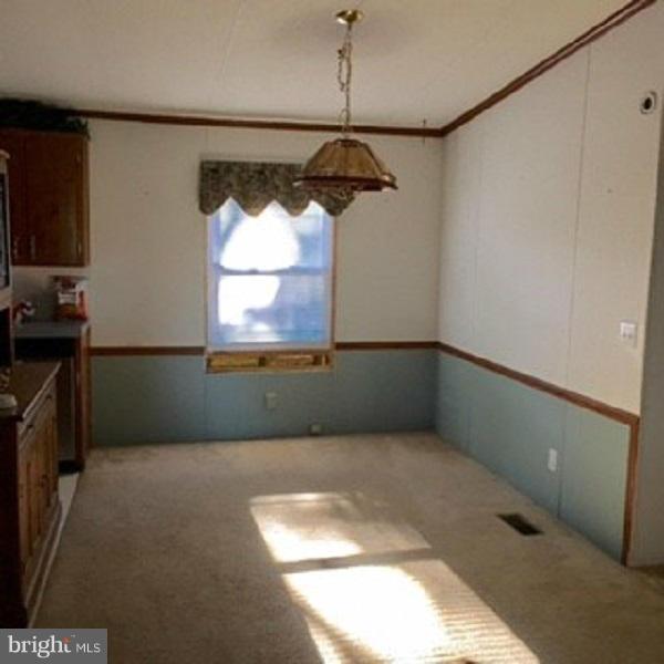 1044 Spielman Road Berkeley Springs, WV 25411 - Photo 13 of 25 a picture of a room with wooden floor and windows
