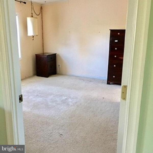 1044 Spielman Road Berkeley Springs, WV 25411 - Photo 14 of 25 an empty room with cabinet and mirror