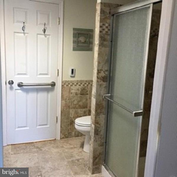 1044 Spielman Road Berkeley Springs, WV 25411 - Photo 17 of 25 a bathroom with a toilet and a shower