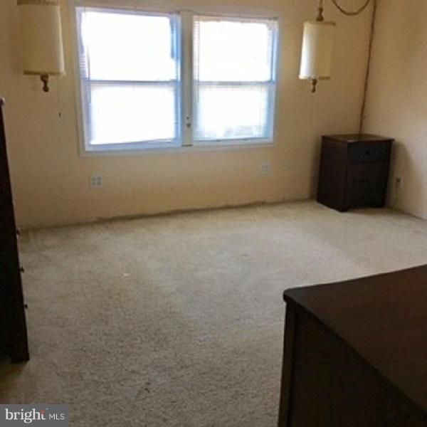1044 Spielman Road Berkeley Springs, WV 25411 - Photo 5 of 25 a view of an empty room with a window