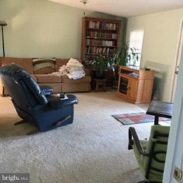1044 Spielman Road Berkeley Springs, WV 25411 - Photo 6 of 25 a bed room with furniture and book shelf