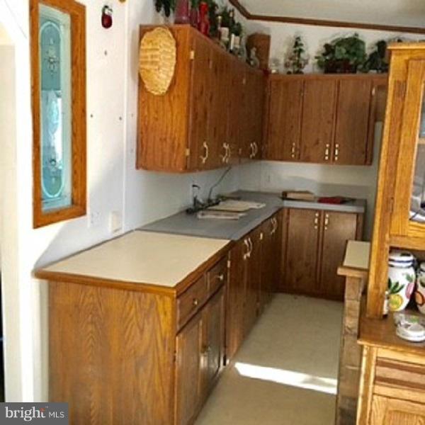 1044 Spielman Road Berkeley Springs, WV 25411 - Photo 9 of 25 a kitchen with a sink and a refrigerator