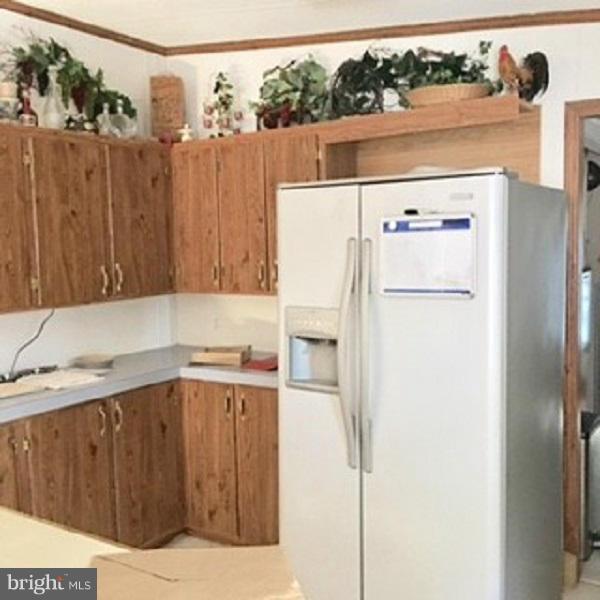 1044 Spielman Road Berkeley Springs, WV 25411 - Photo 10 of 25 a white refrigerator freezer sitting inside of a kitchen