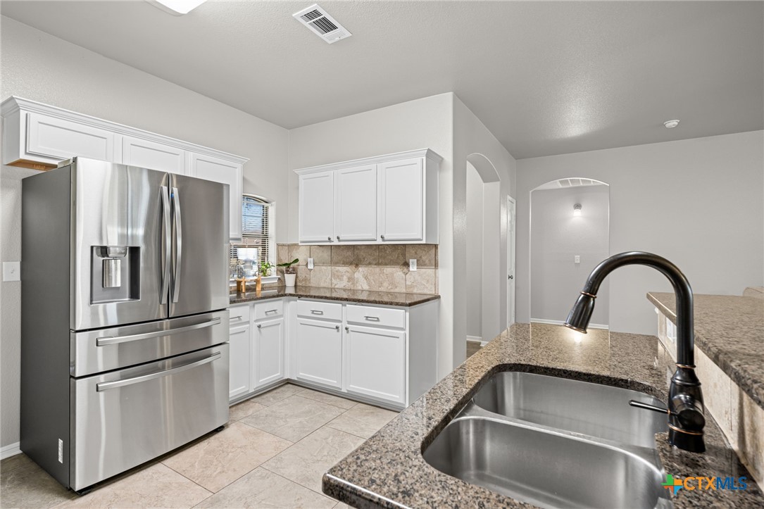4712 Ramhorn Killeen, TX 76542 - Photo 11 of 27 a kitchen with a refrigerator sink and cabinets