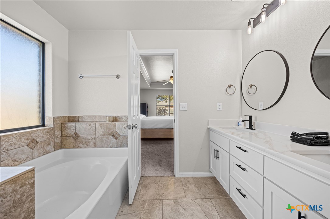 4712 Ramhorn Killeen, TX 76542 - Photo 15 of 27 a bathroom with a tub sink and mirror