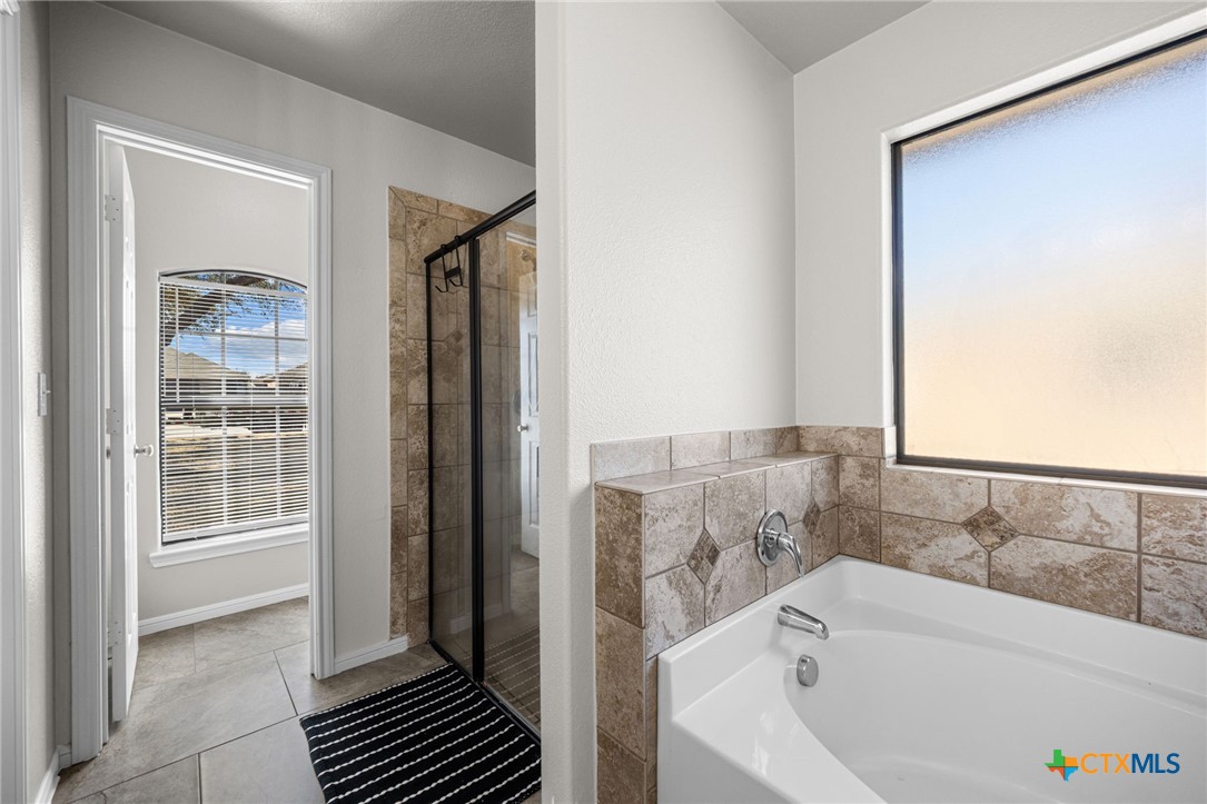 4712 Ramhorn Killeen, TX 76542 - Photo 16 of 27 a bathroom with a bathtub and a shower
