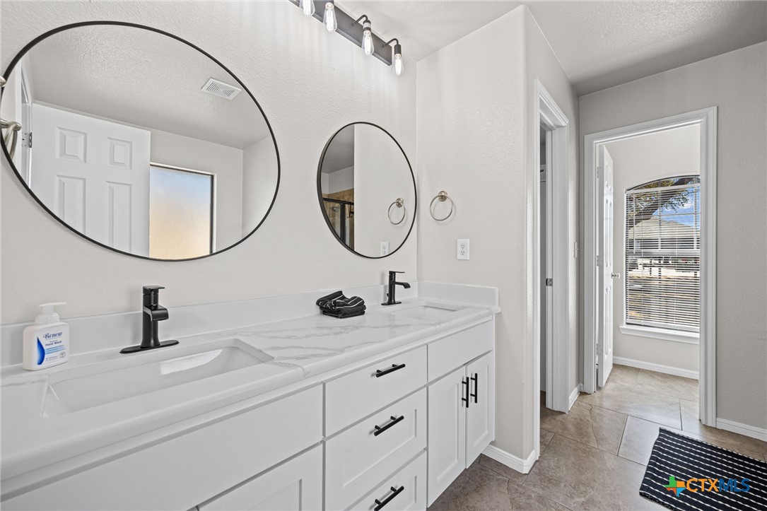 4712 Ramhorn Killeen, TX 76542 - Photo 17 of 27 a bathroom with a double vanity sink and a mirror
