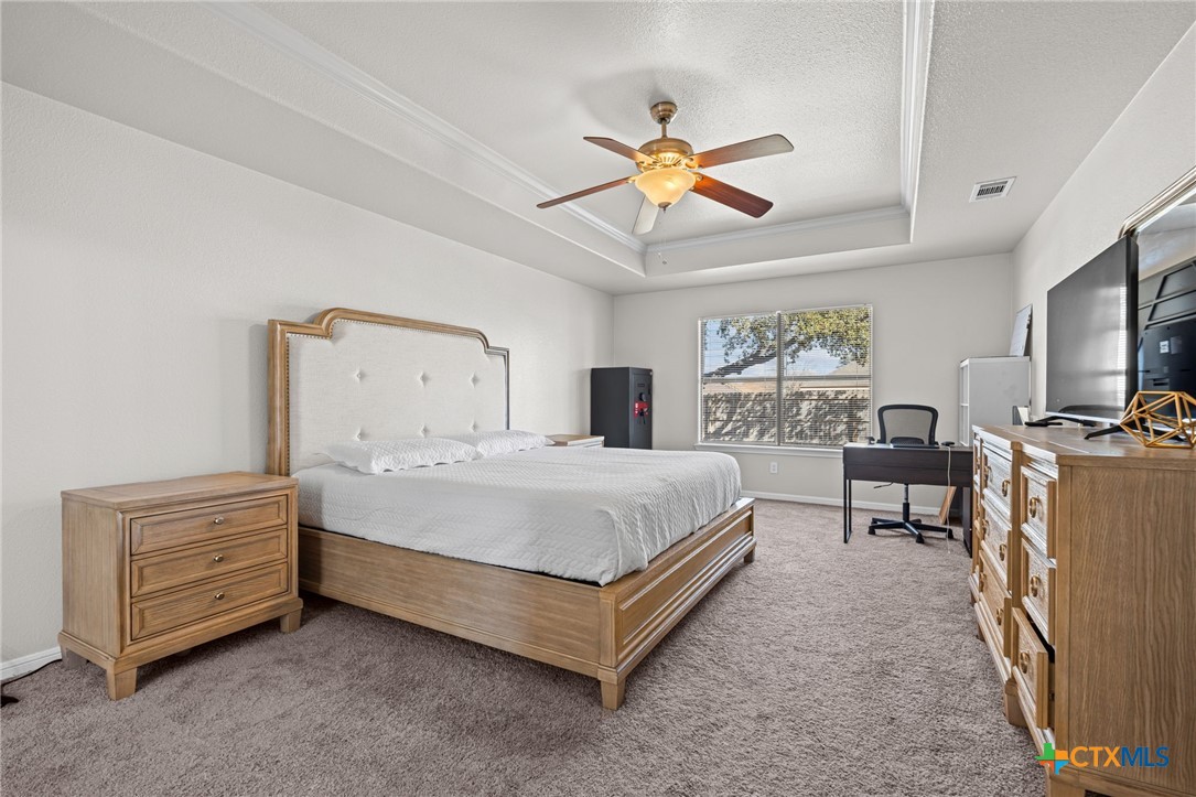 4712 Ramhorn Killeen, TX 76542 - Photo 19 of 27 a spacious bedroom with a bed and a chandelier