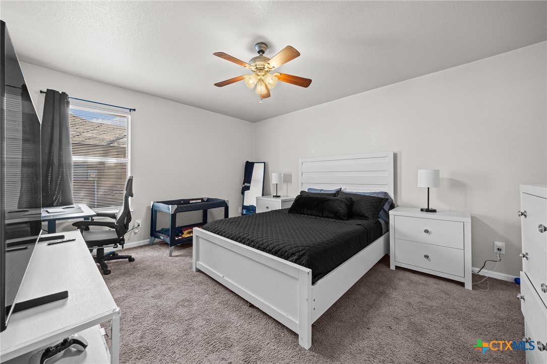 4712 Ramhorn Killeen, TX 76542 - Photo 20 of 27 a living room with furniture and a chandelier