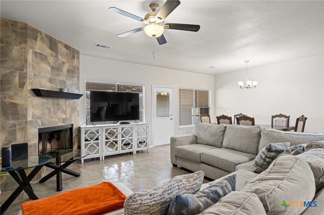 4712 Ramhorn Killeen, TX 76542 - Photo 6 of 27 a living room with furniture flat screen tv and a fireplace