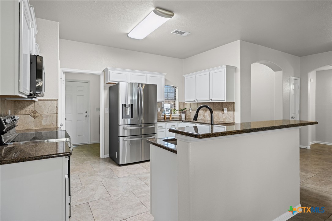 4712 Ramhorn Killeen, TX 76542 - Photo 9 of 27 a view of a kitchen with a sink and refrigerator