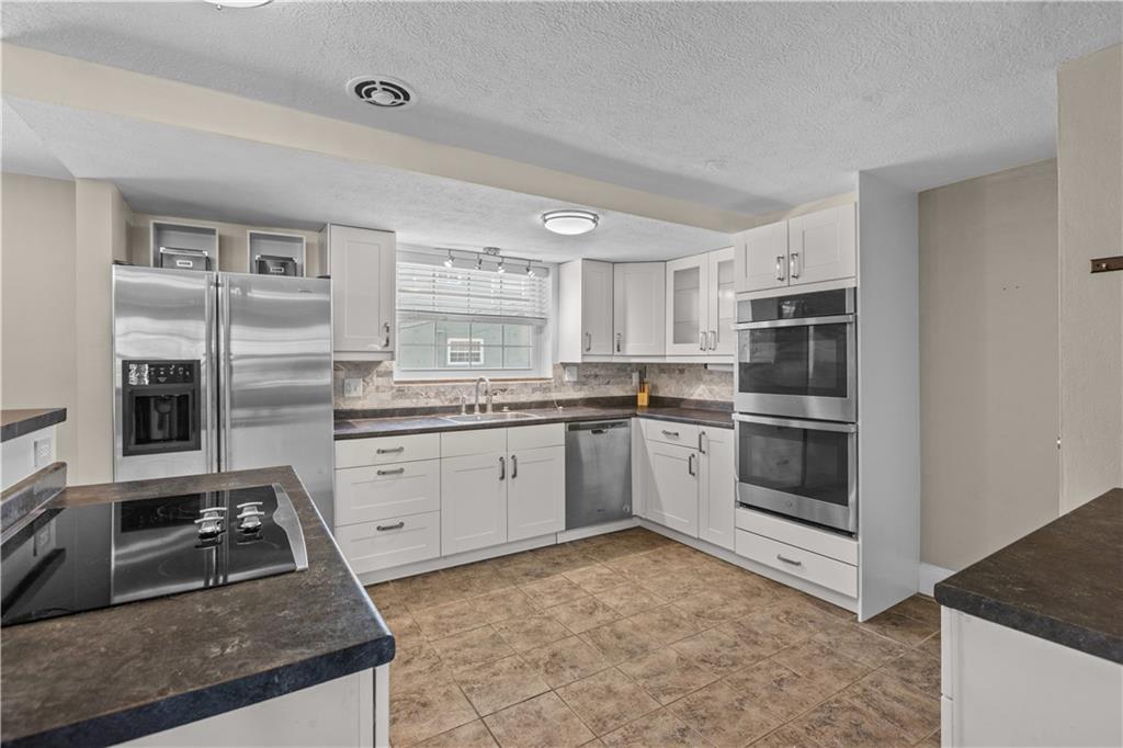 109 Raleigh Court Pittsburgh, PA 15237 - Photo 5 of 21 a kitchen with stainless steel appliances granite countertop a stove a sink and a refrigerator