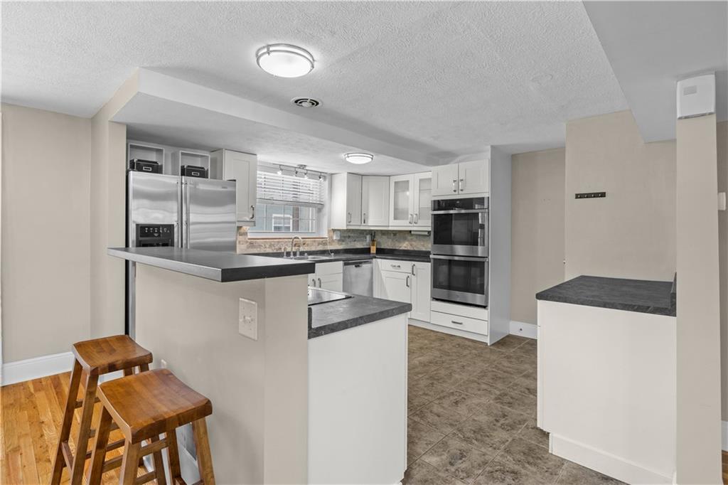 109 Raleigh Court Pittsburgh, PA 15237 - Photo 6 of 21 a kitchen with stainless steel appliances granite countertop a refrigerator and a stove top oven