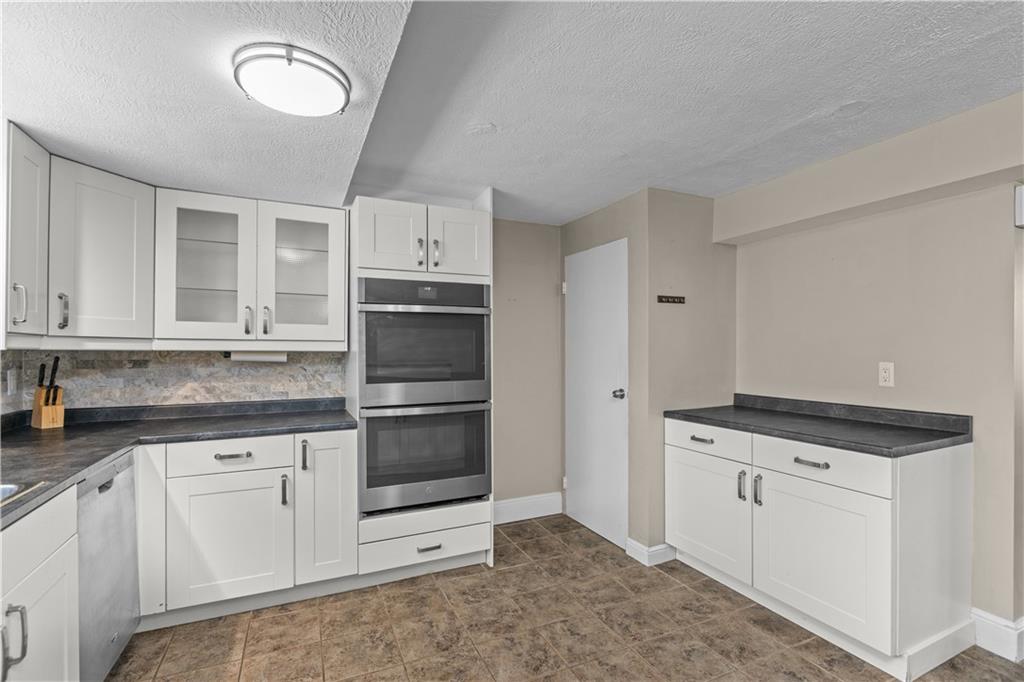 109 Raleigh Court Pittsburgh, PA 15237 - Photo 7 of 21 a kitchen with granite countertop white cabinets and stainless steel appliances