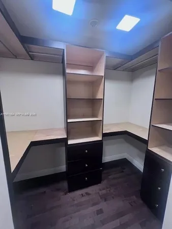 a room with closet and wooden floor