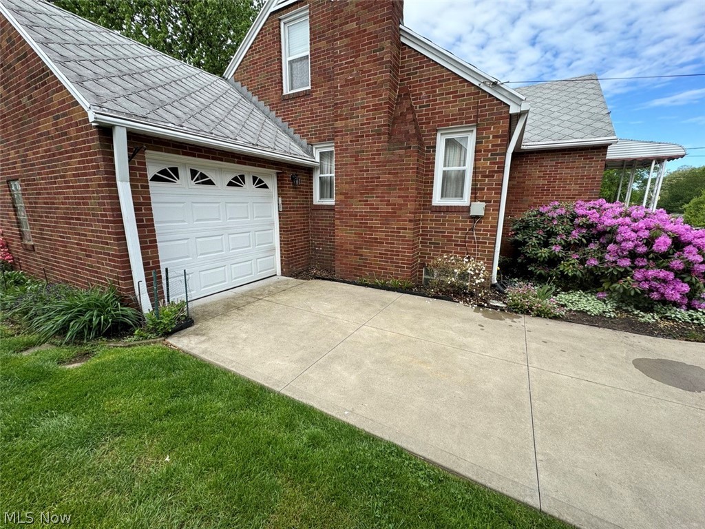 4426 2nd Street Northwest Canton, OH 44708 - Photo 5 of 20 View of side of property featuring a garage and a lawn