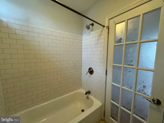 a bathroom with a bathtub and a shower
