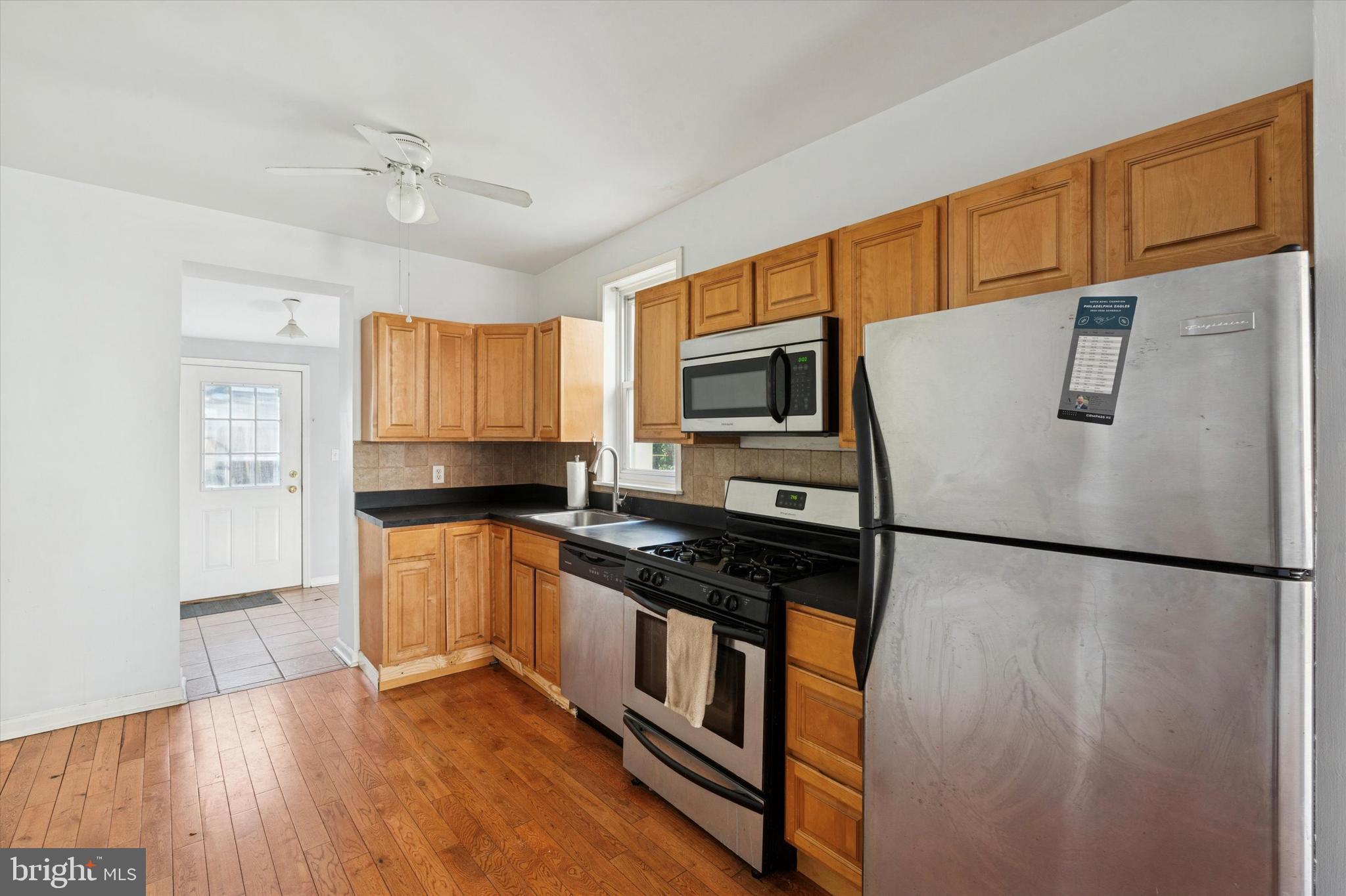 102 Daly Street Philadelphia, PA 19148 - Photo 6 of 25 a kitchen with stainless steel appliances granite countertop a refrigerator a stove a sink dishwasher and a refrigerator