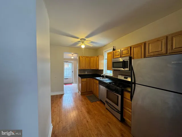 a kitchen with stainless steel appliances granite countertop a stove and a refrigerator
