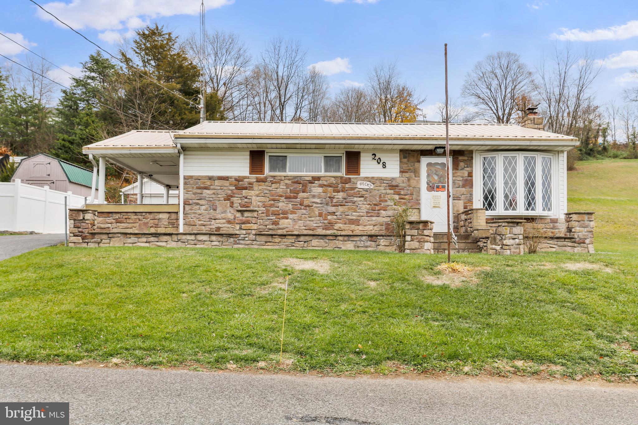 208 Fulton Street Hancock, MD 21750 - Photo 1 of 33 a front view of a house with a yard