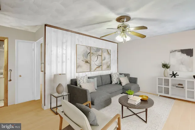 a living room with furniture and a chandelier