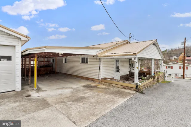 a view of a white house with a yard
