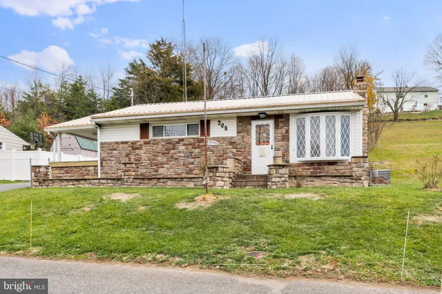 a front view of house with yard and seating area