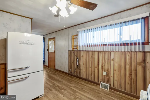 a view of a hallway with a ceiling fan