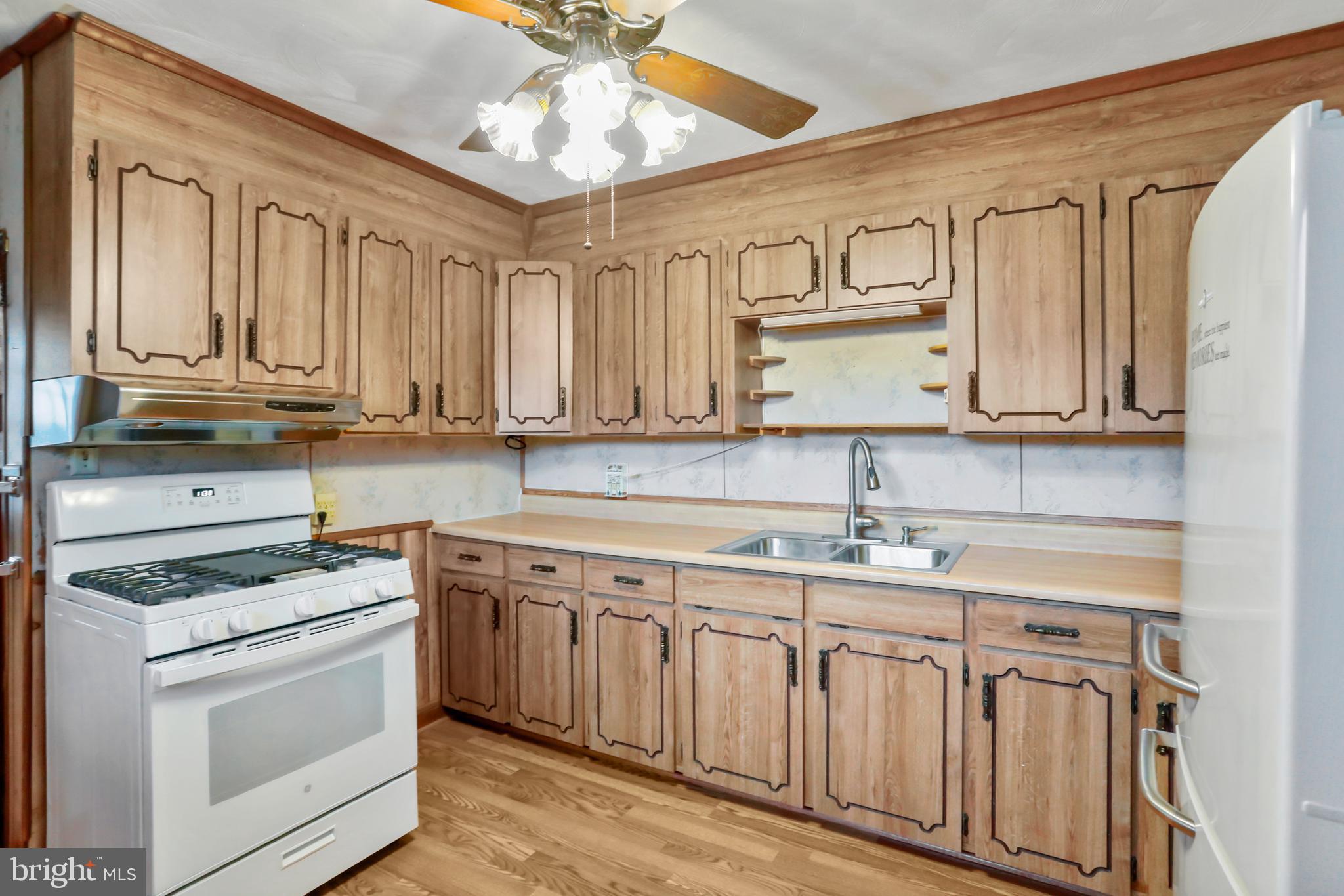 208 Fulton Street Hancock, MD 21750 - Photo 7 of 33 a kitchen with stainless steel appliances granite countertop a stove sink and cabinets