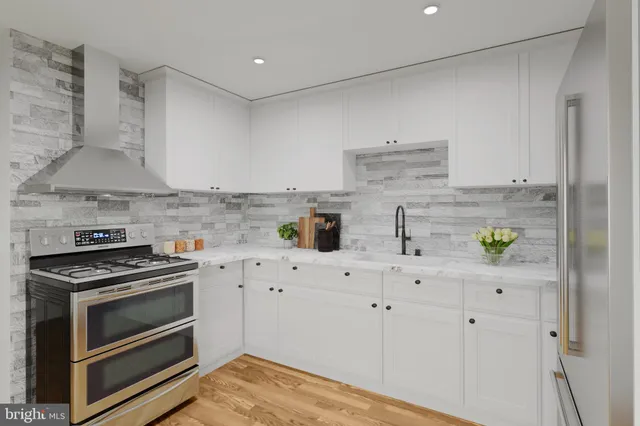 a kitchen with white cabinets and appliances