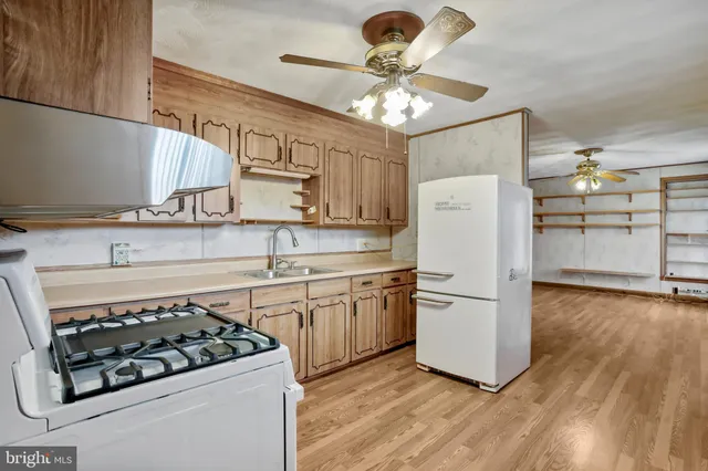 a kitchen with a stove a refrigerator and a fireplace