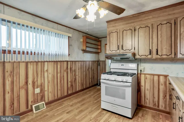 a kitchen with wooden cabinets and a stove top oven