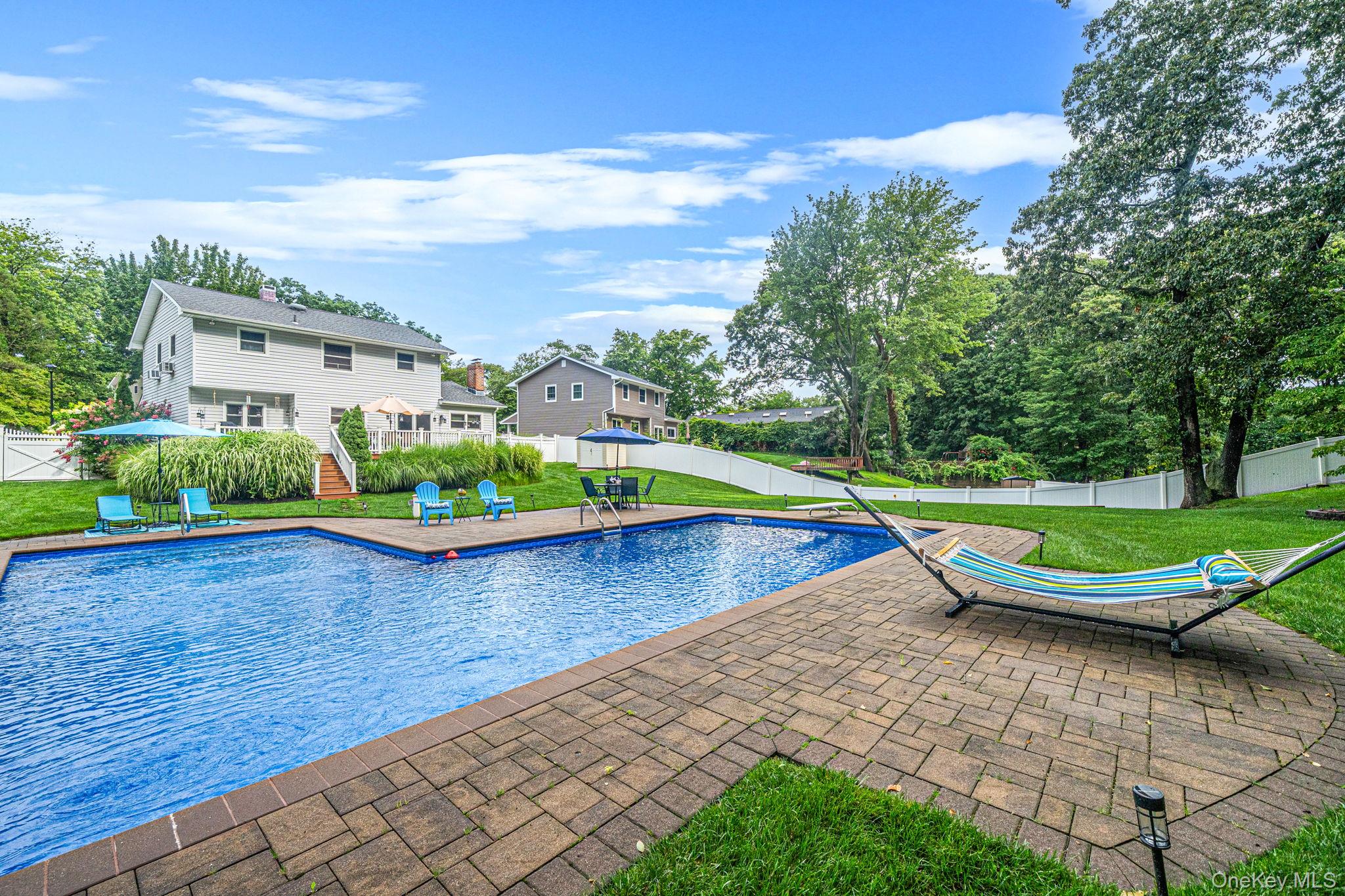 5 Rockhill Road Rocky Point, NY 11778 - Photo 41 of 48 Expansive backyard featuring a large in-ground pool with integrated steps, surrounded by a paver patio